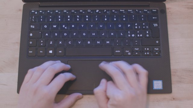 Typing on a black laptop
