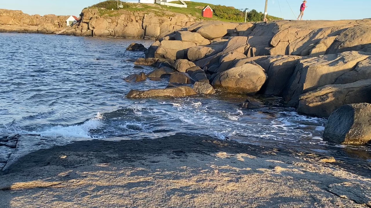 Nubble Lighthouse - Beautiful scene of water crashing and golden sunset at Nubble Light house - Landmarks & Historical Buildings Near Me - York, Maine