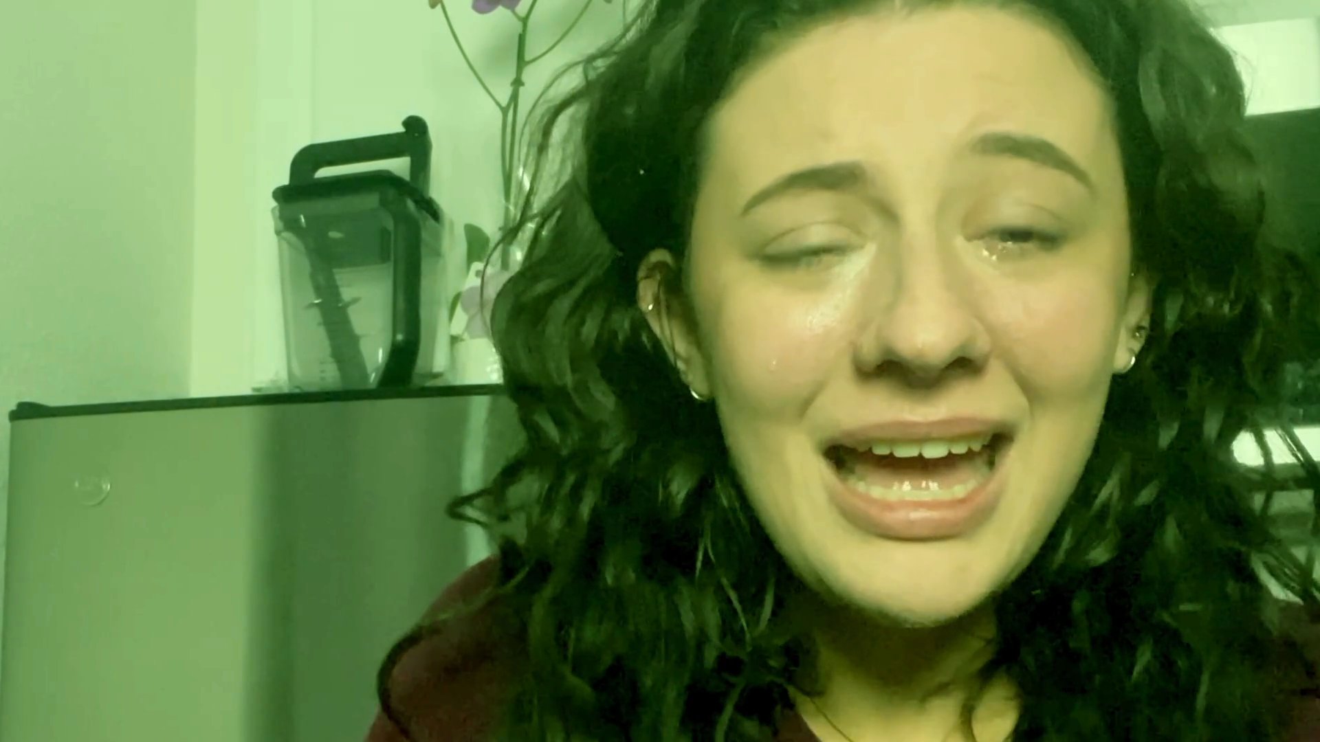 A young woman displays visible distress and tears while speaking, followed by a middle-aged man providing a steady, conversational response to the situation.