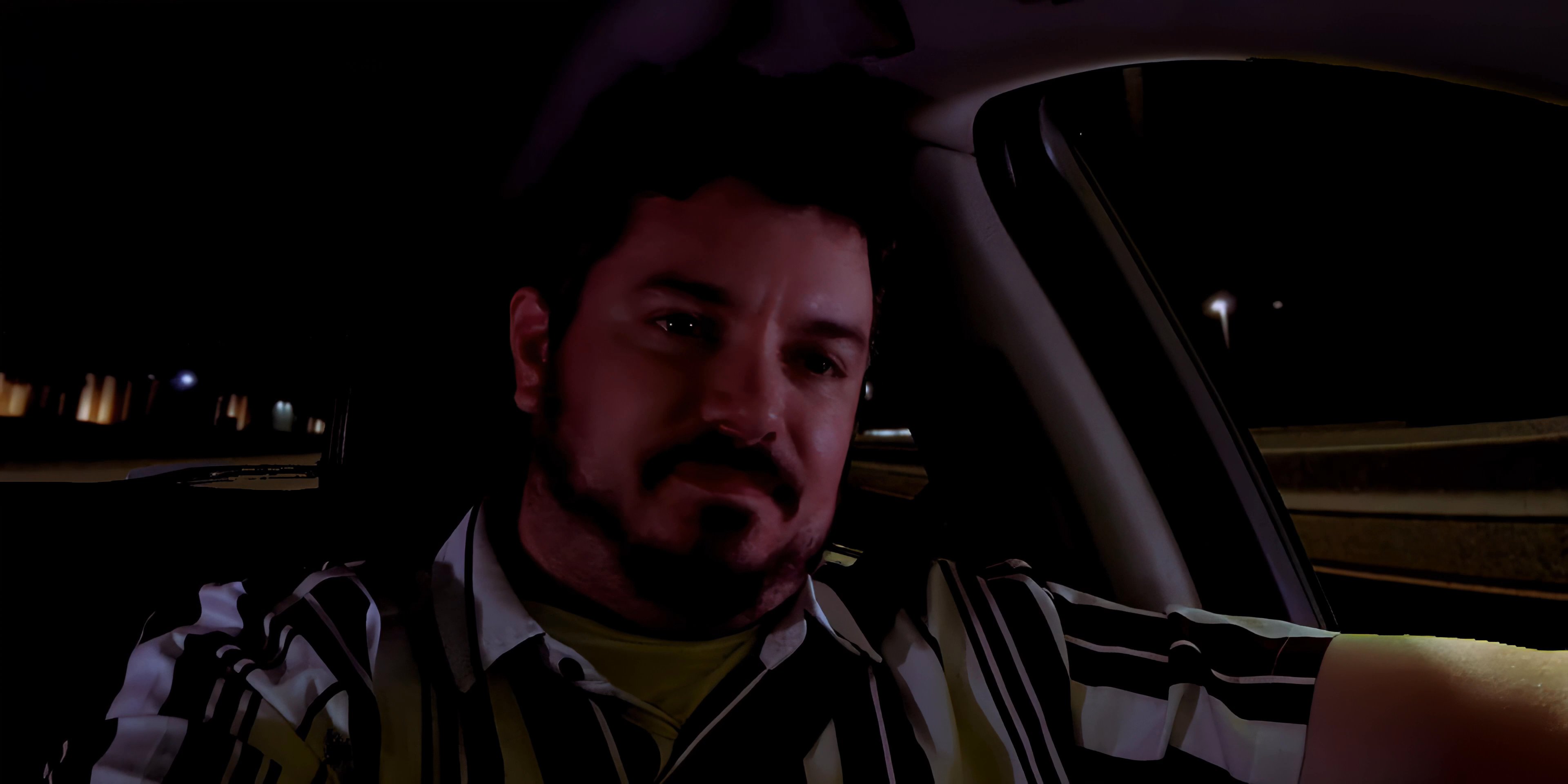 A man engages in a hands-free phone conversation while driving at night. The focus shifts between the driver and his smartphone display showing an active call.