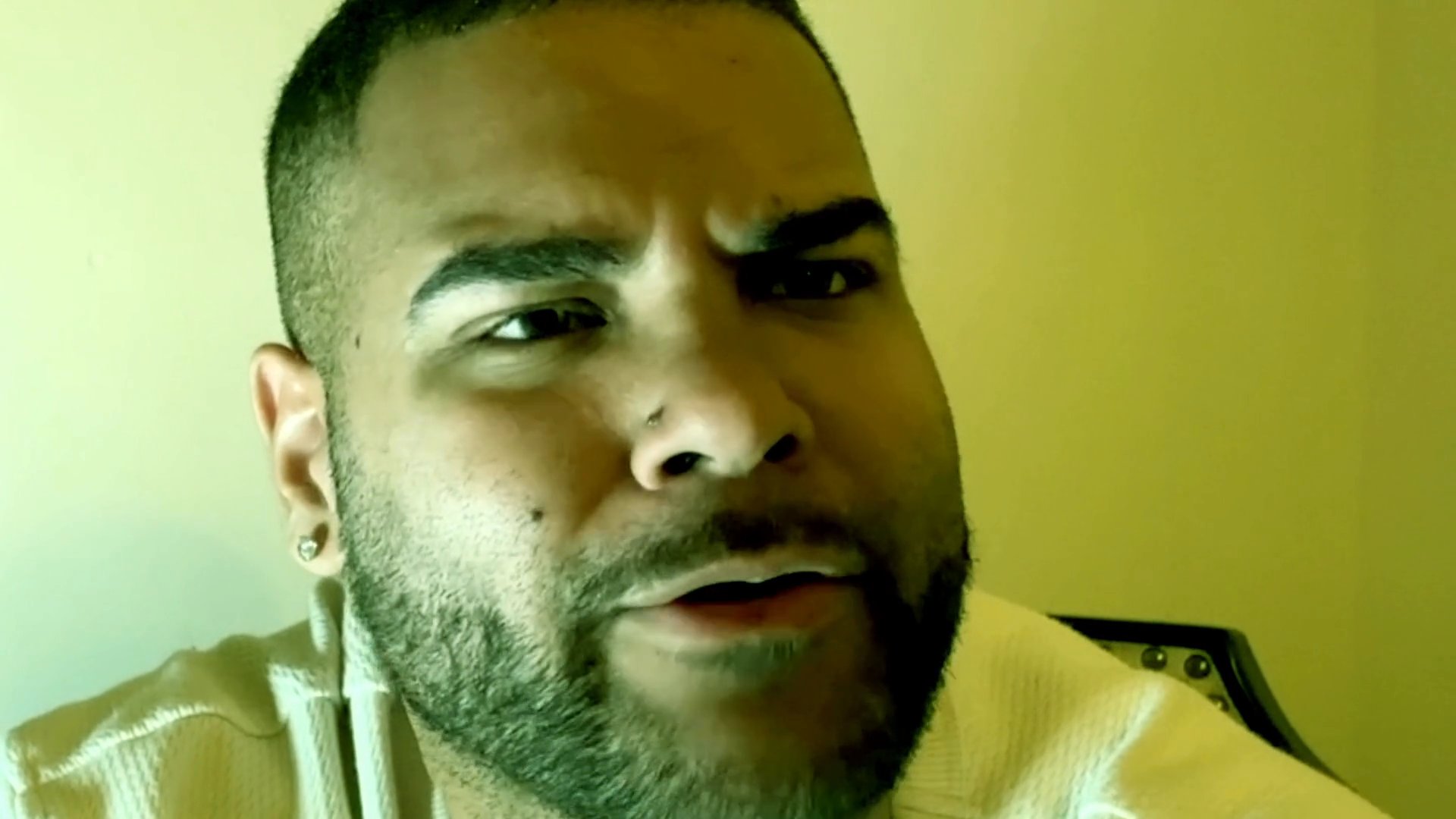 A man addresses the camera directly, sharing thoughts through a monologue with varied facial expressions.