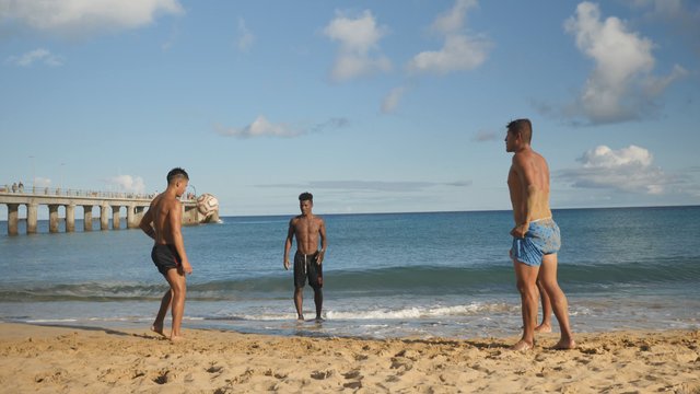 Playing football on a beach