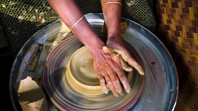 Woman making a clay pot