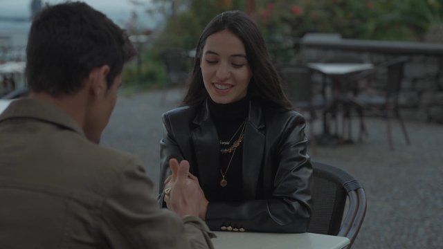 A girl playing Thumb War with her boyfriend