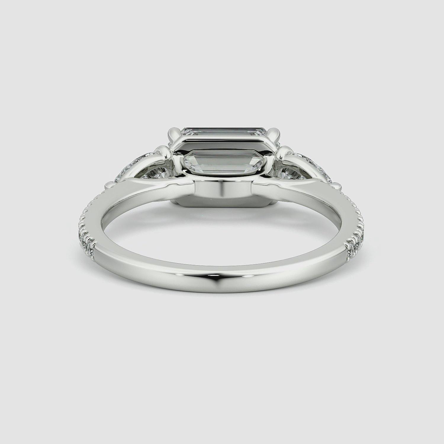 The Three Stone | Emerald | 18k | White Gold | bandAccent: Pavé | diamondOrientation: horizontal | sideStoneCarat: 0.25ct | sideStoneShape: Pear | caratWeight: other