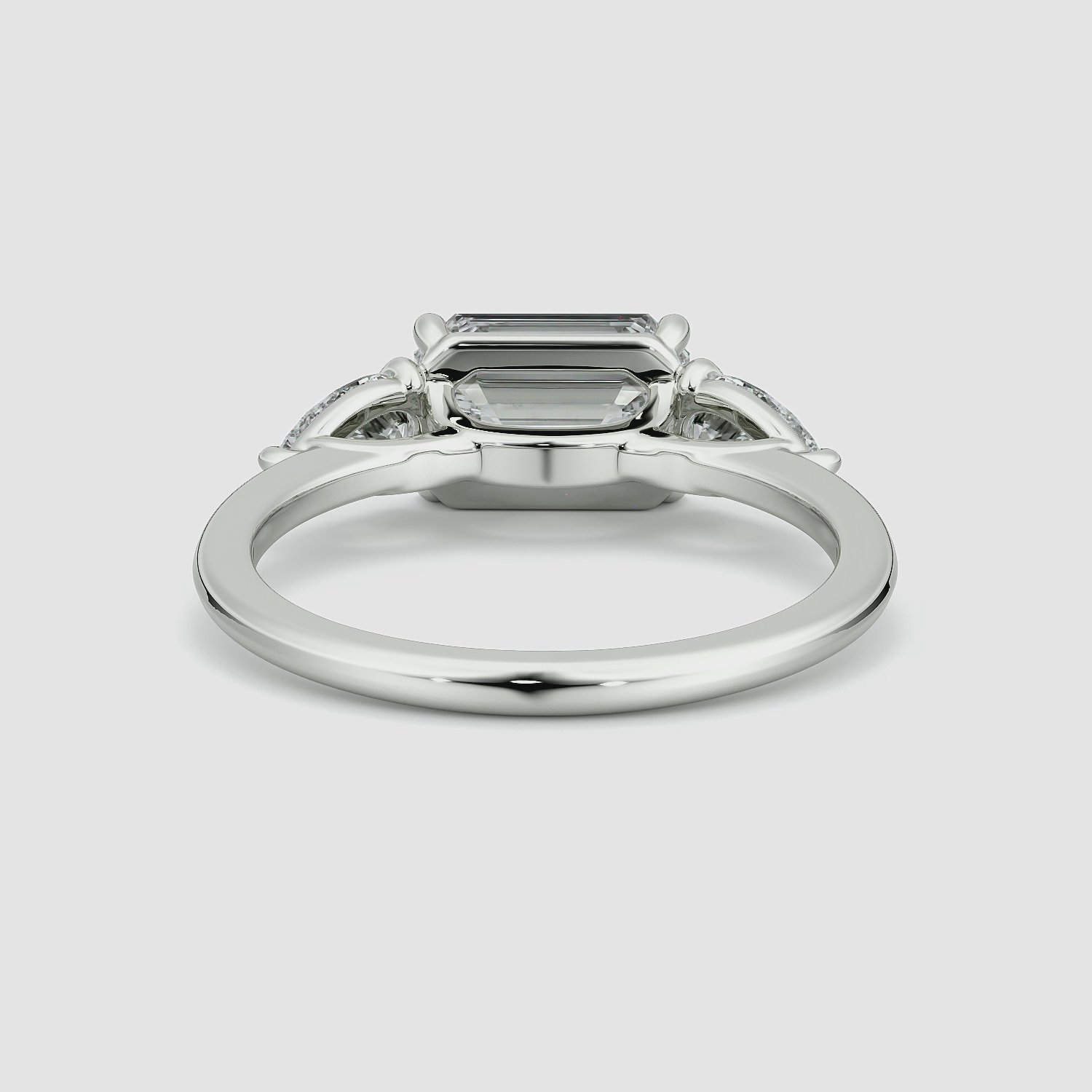 The Three Stone | Emerald | 18k | White Gold | bandAccent: Plain | diamondOrientation: horizontal | sideStoneCarat: 0.25ct | sideStoneShape: Pear | caratWeight: other