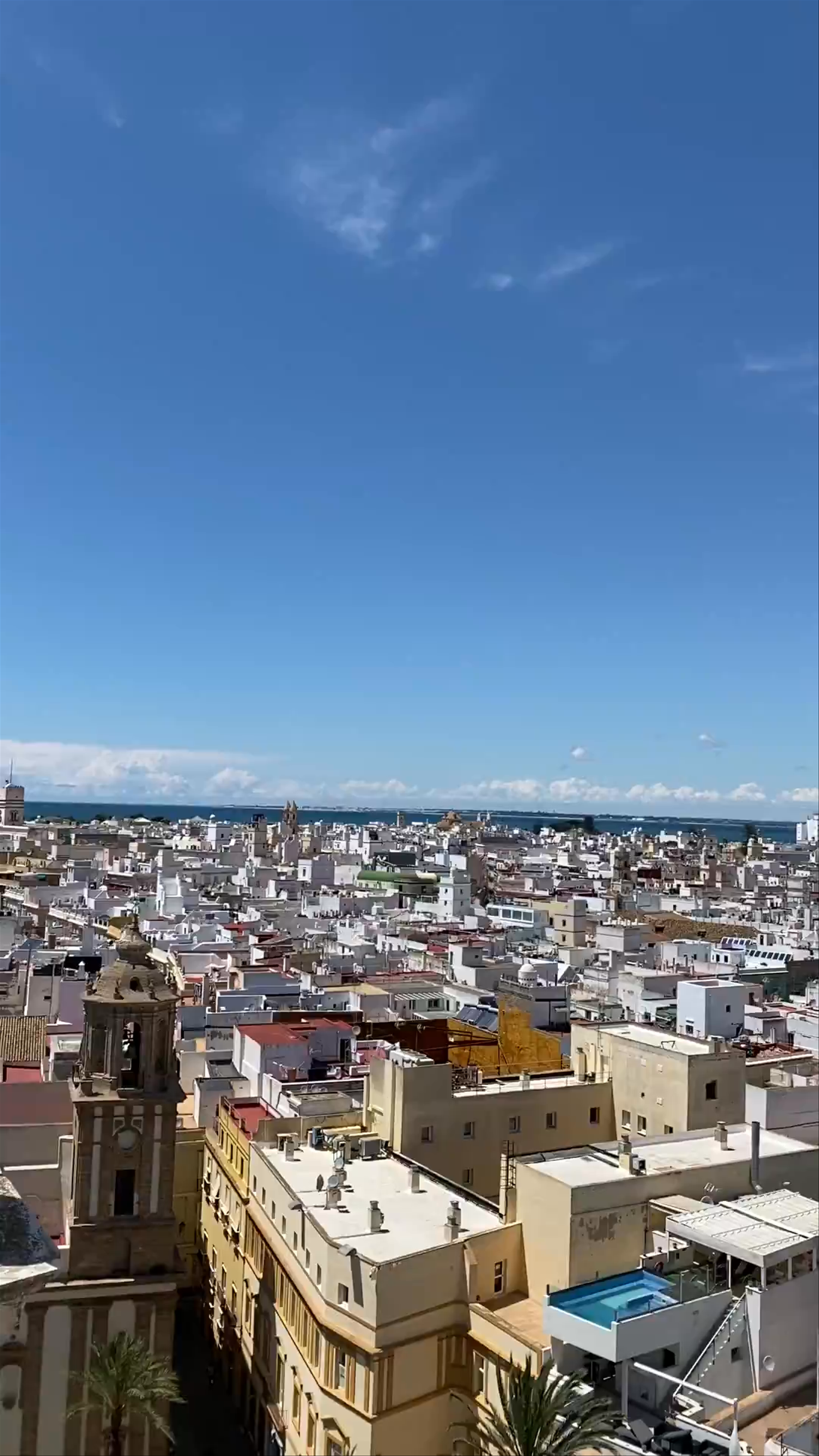 Cadiz Cathedral Rooftop Views: Sunlit Cityscape and Ocean Horizon