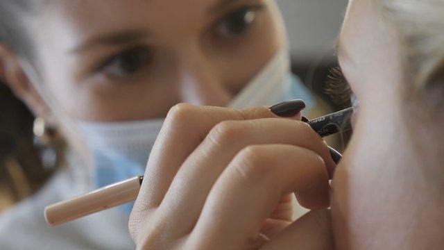 Makeup artist applying eyeliner
