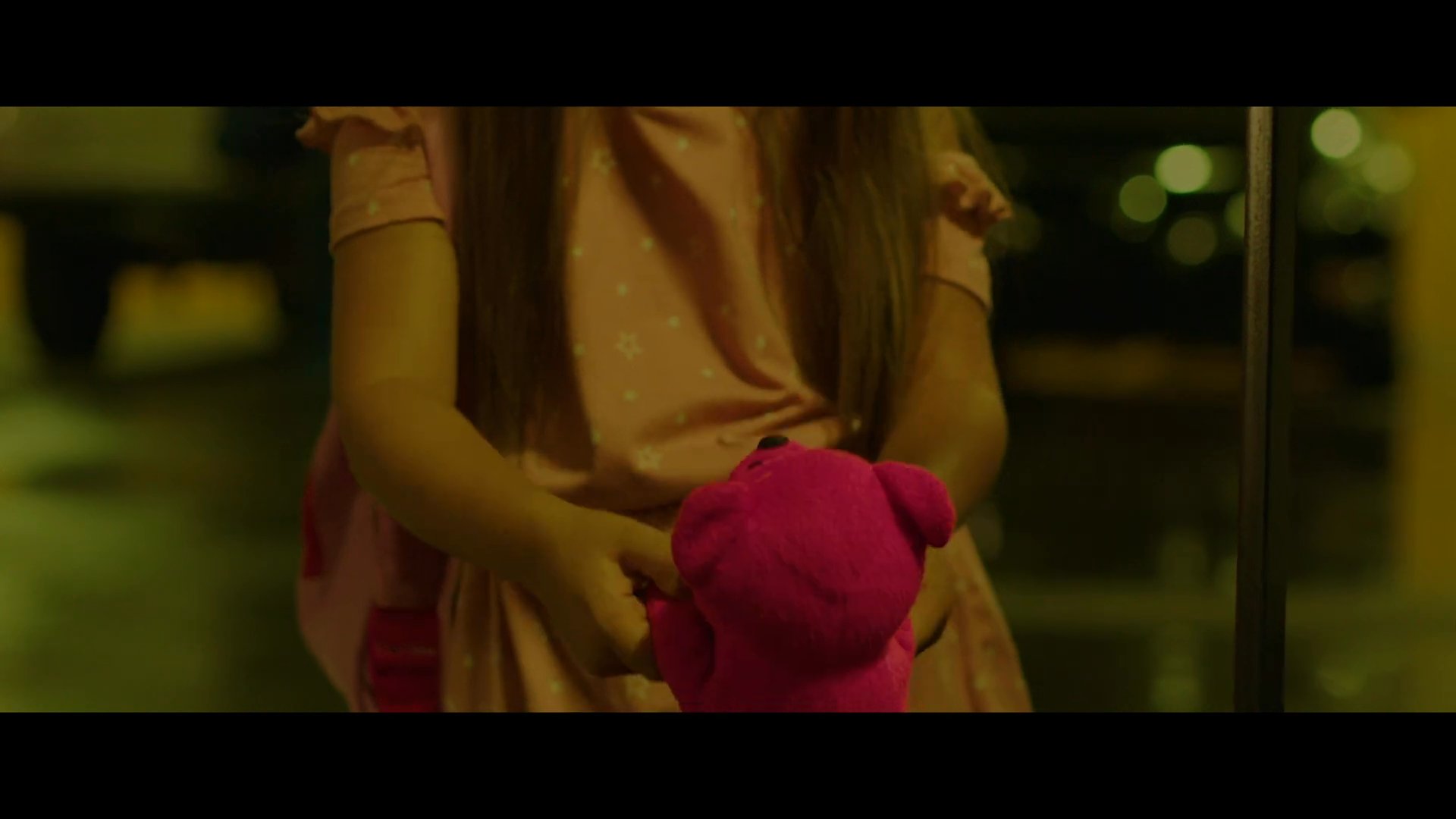 A woman and her young child face a sudden threat from a masked intruder while in a dimly lit parking garage. The encounter escalates quickly as the assailant approaches from a nearby van.