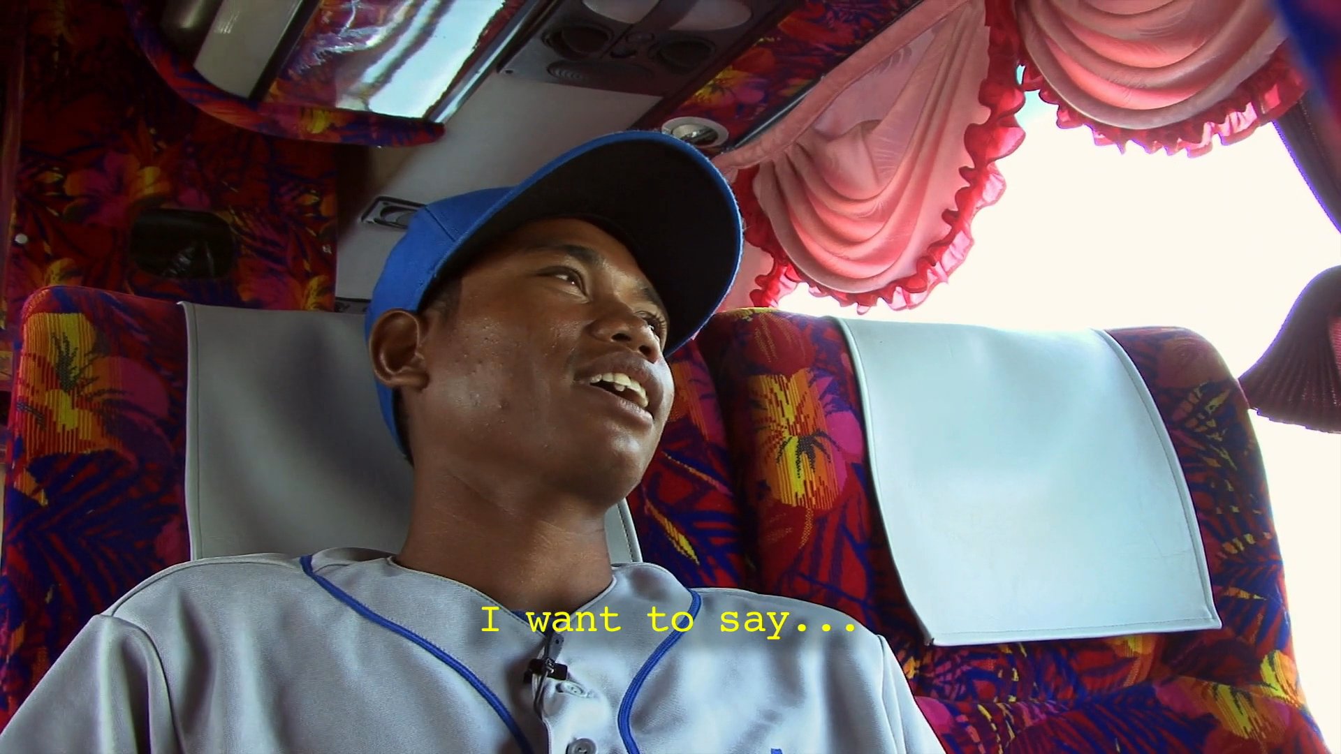 A baseball player sitting on a team bus expresses concern regarding potential loss and the subsequent reaction of his coaches and teammates. He reflects on his team's status as newcomers to the game and their desire to avoid a poor performance.