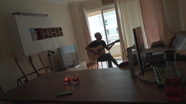 A guy playing his guitar spontaneously 