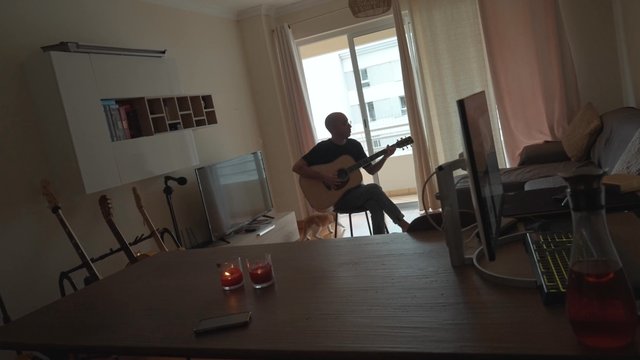 A guy playing his guitar spontaneously