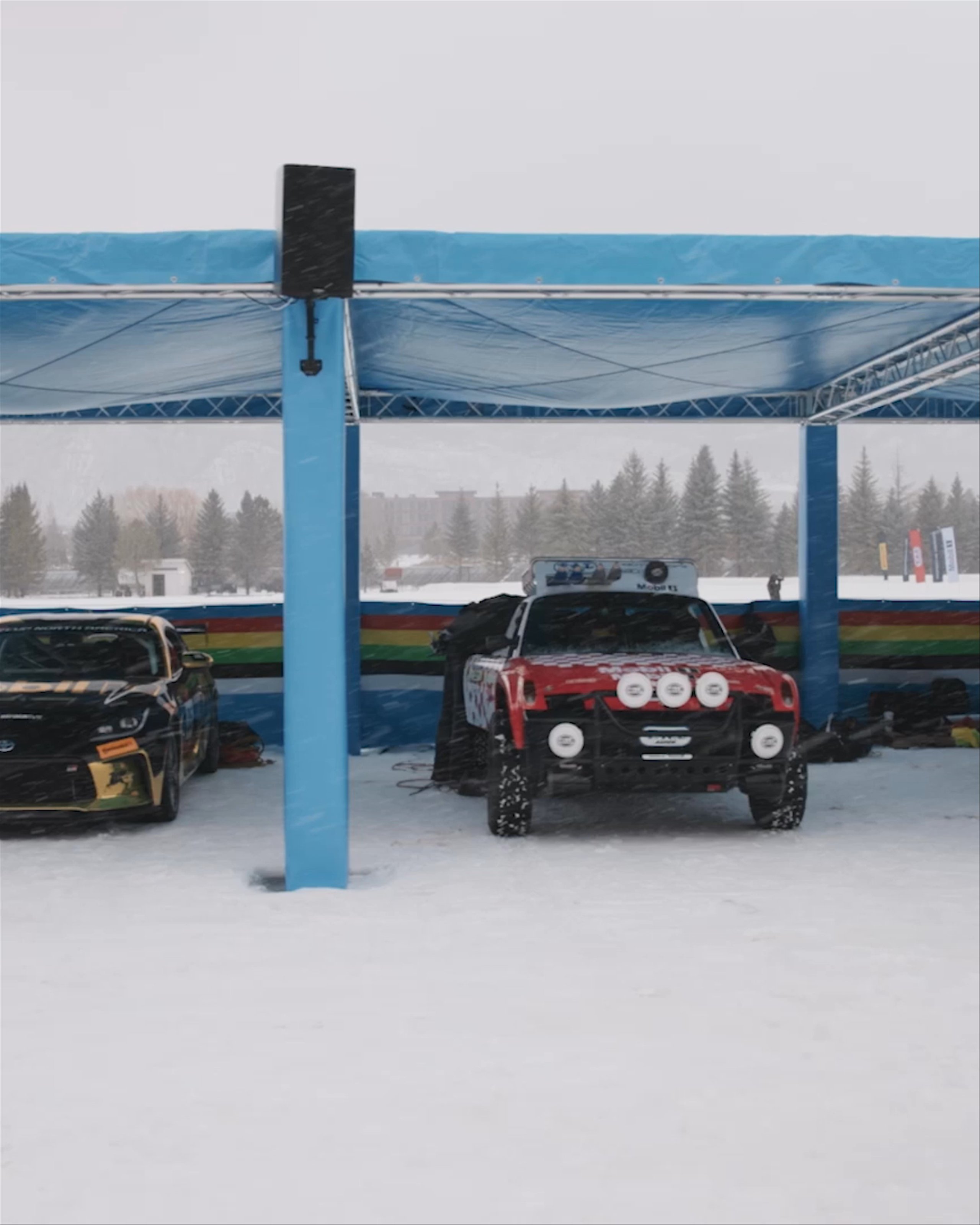 Panning view of various cars in the pit