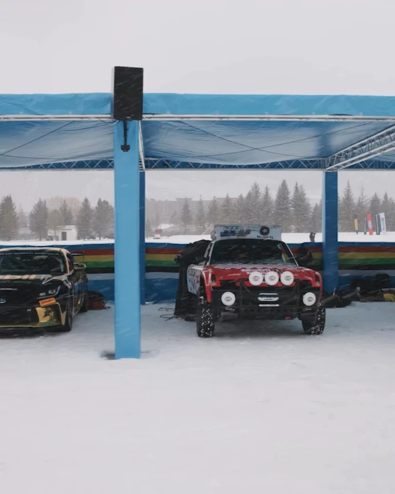 Panning view of various cars in the pit