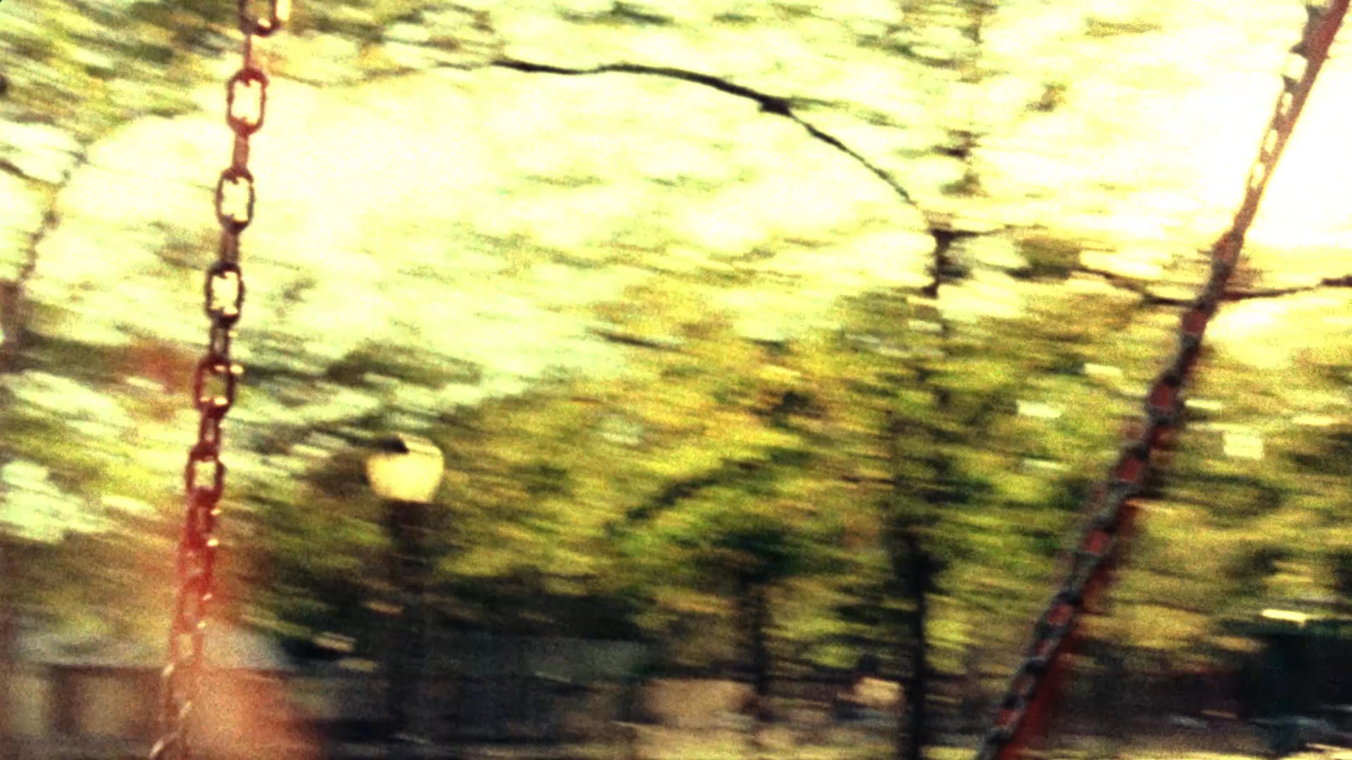An individual reviews a collection of family photographs alongside an analog tape recorder, transitioning between personal memories and recorded audio reflections. The sequence moves from a reflective desktop setting to nostalgic scenes of a family portrait.
