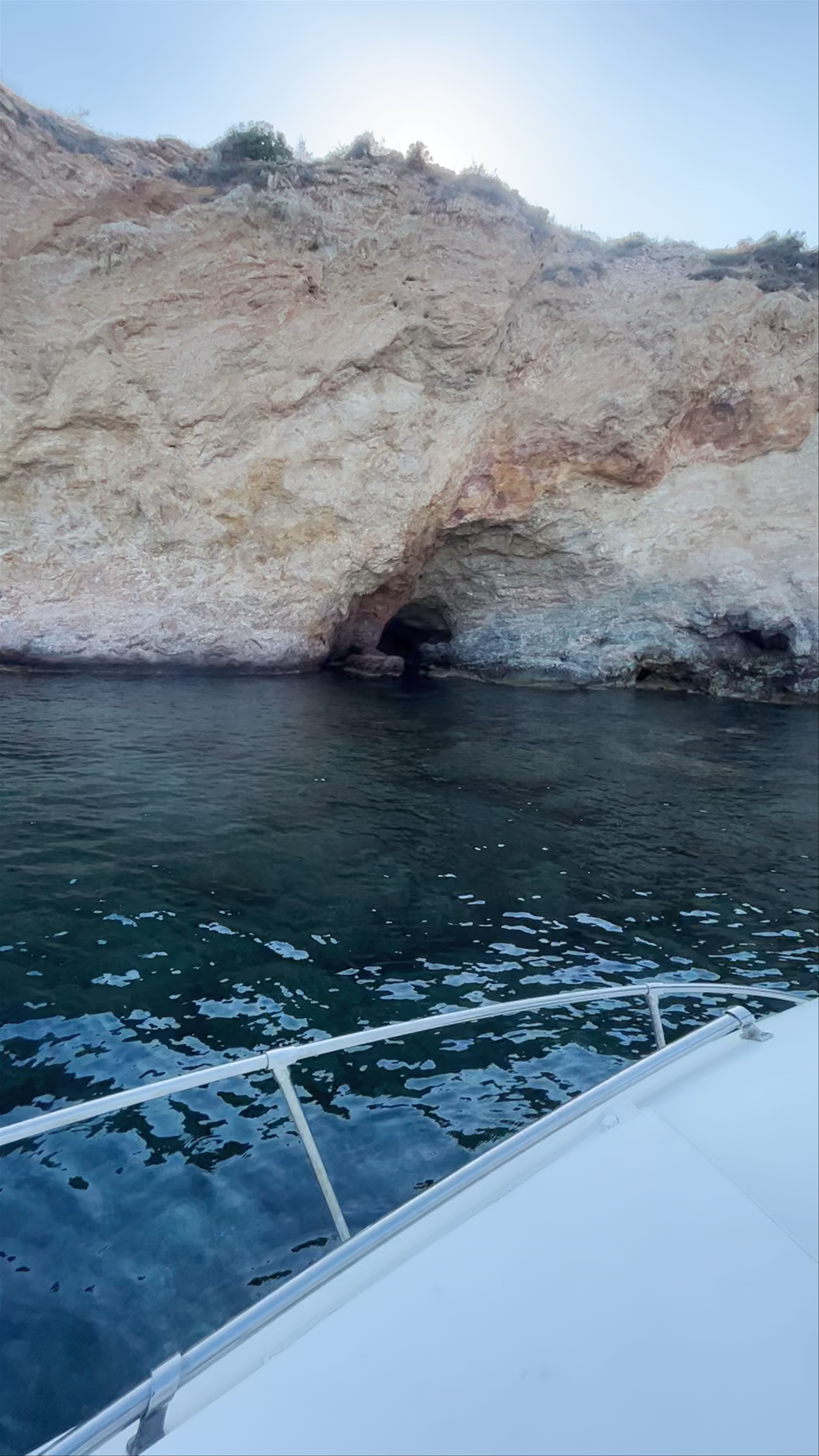 Serene Coastal Boat Ride Along Rocky Coves in Fléves, Greece