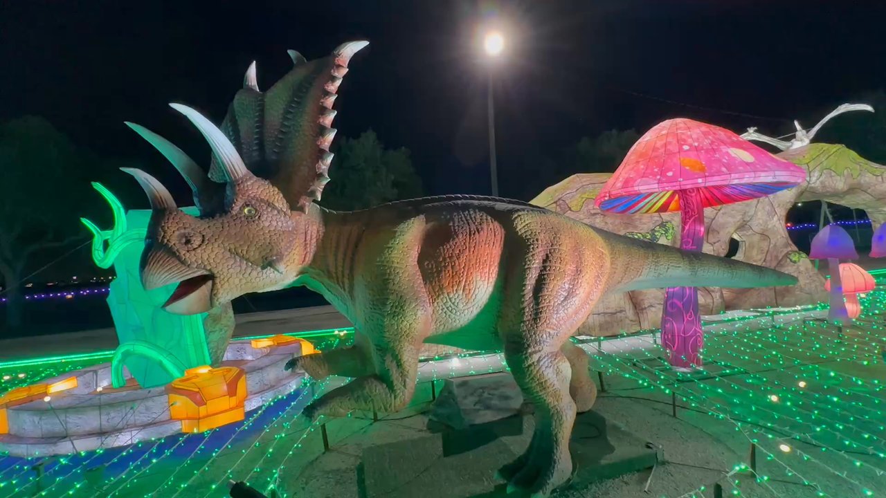 Magical Winter Lights - One of the Dinosaurs moving - Festivals Near Me - Rosenberg, Texas