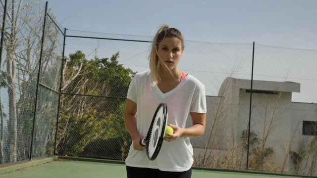 A woman serving in a tennis match