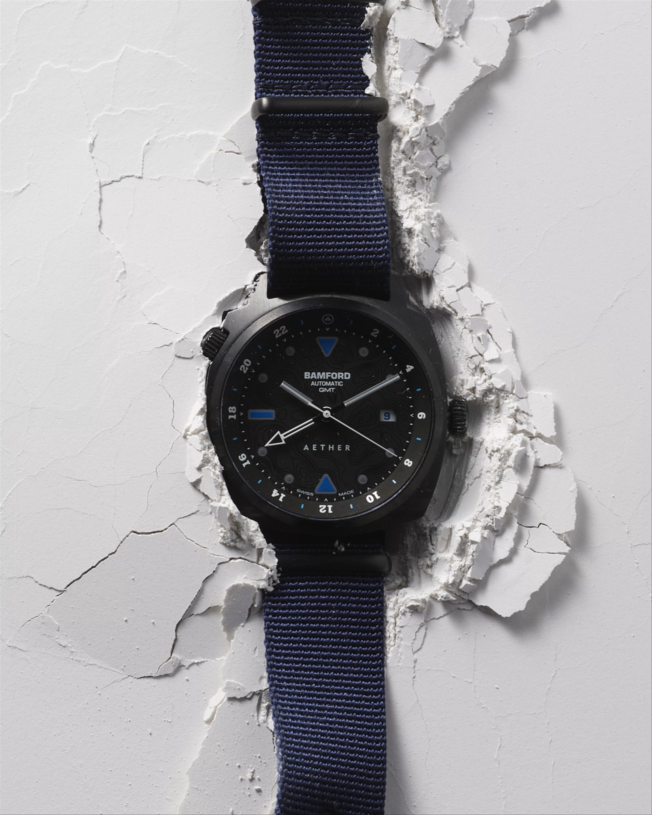 AETHER Bamford watch sitting into broken white surface with animated second hand rotating