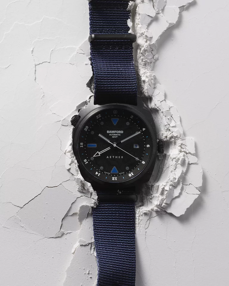 Video of Bamford watch sitting on cracked white surface with seconds hand looping
