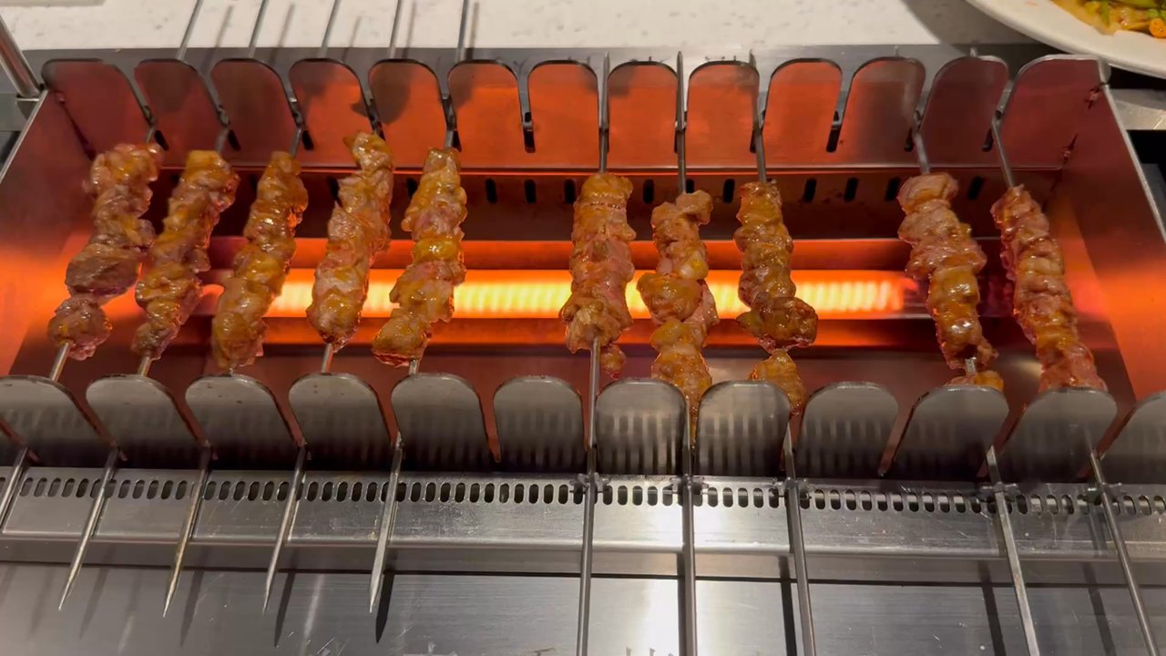 Hao Fu Men BBQ - Automatic meat skewer cooker on the table. - Barbeque Near Me - Queens, New York