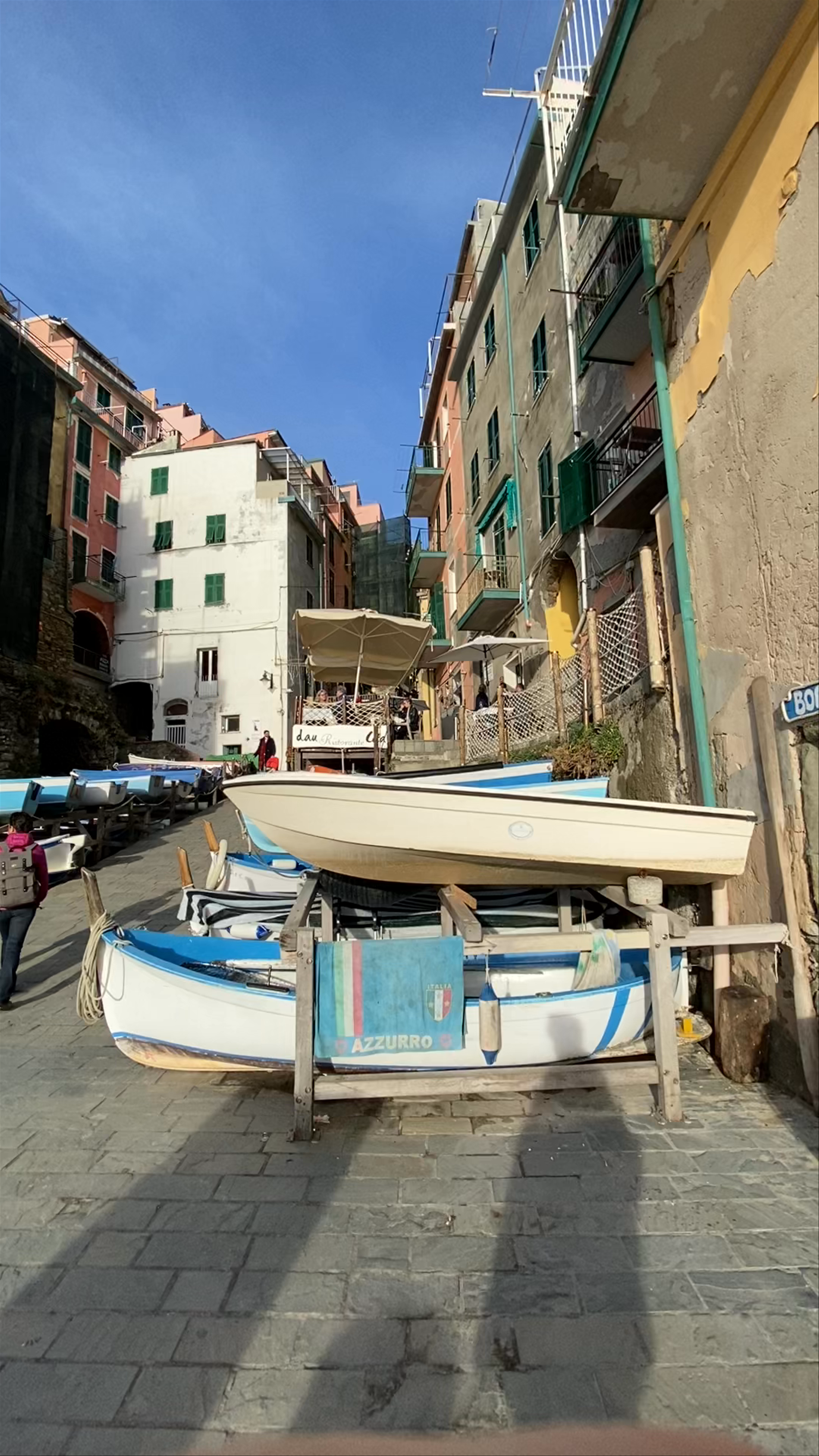 Riomaggiore Coastal Charm: Sunlit Alleys and Colorful Boats