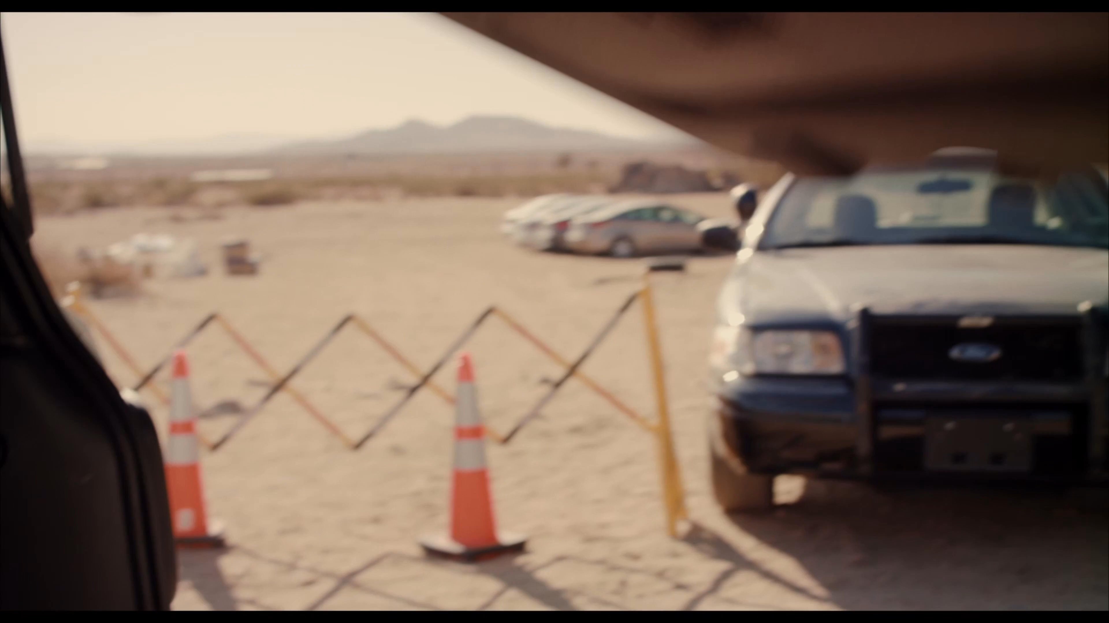 DEA agents conduct a desert investigation involving a suspect in custody, a tactical k9 unit, and the search of a vehicle trunk for evidence.