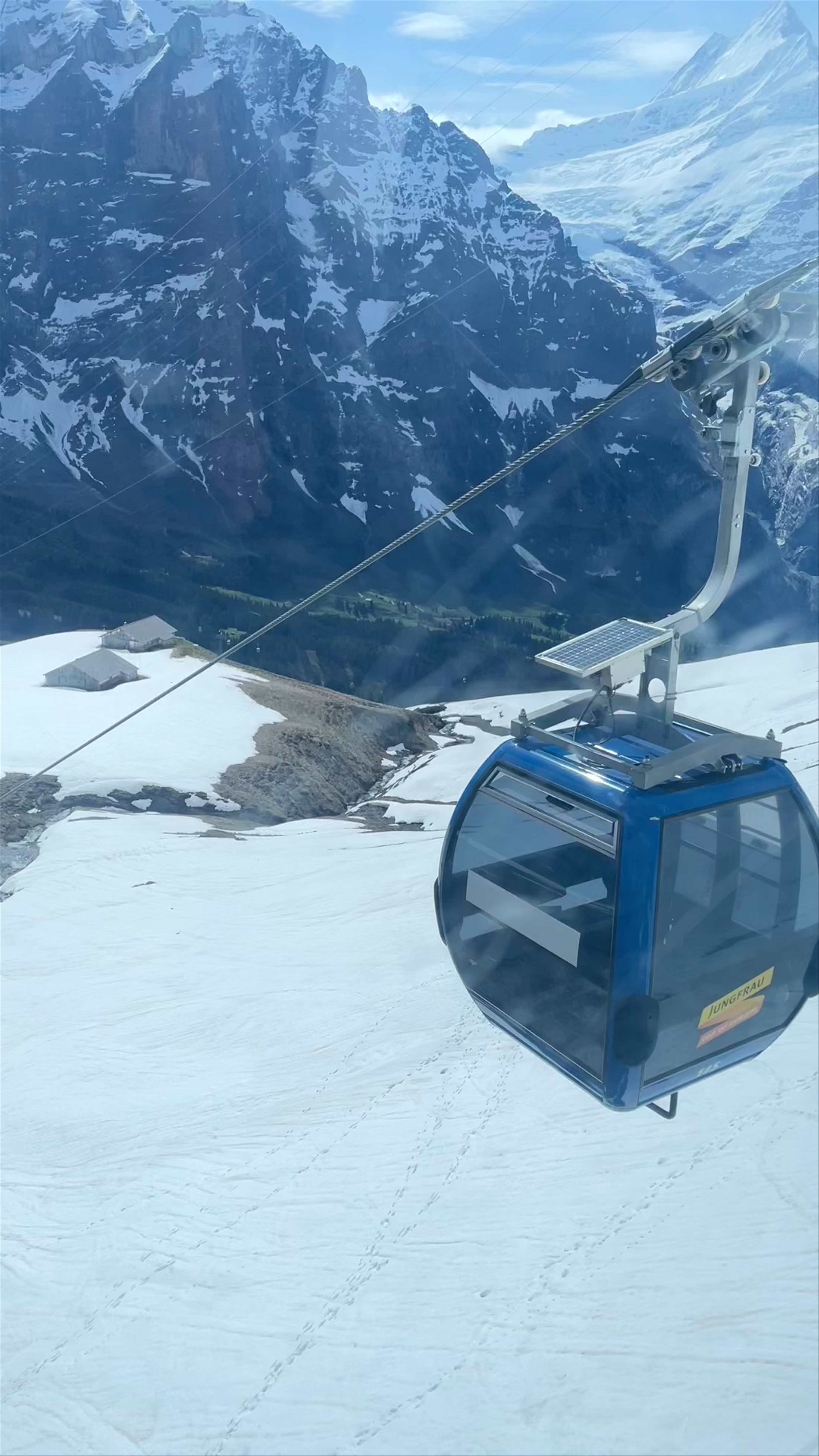 First, Grindelwald: Stunning Alpine Cable Car Ride with Majestic Snow-Capped Peaks