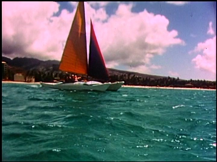 An elderly man recounts his maritime experiences while the film transitions between his testimonial and archival footage of sailboats and surfers navigating ocean waves.
