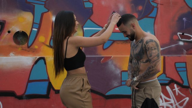 Woman adjusts her boyfriend's hair