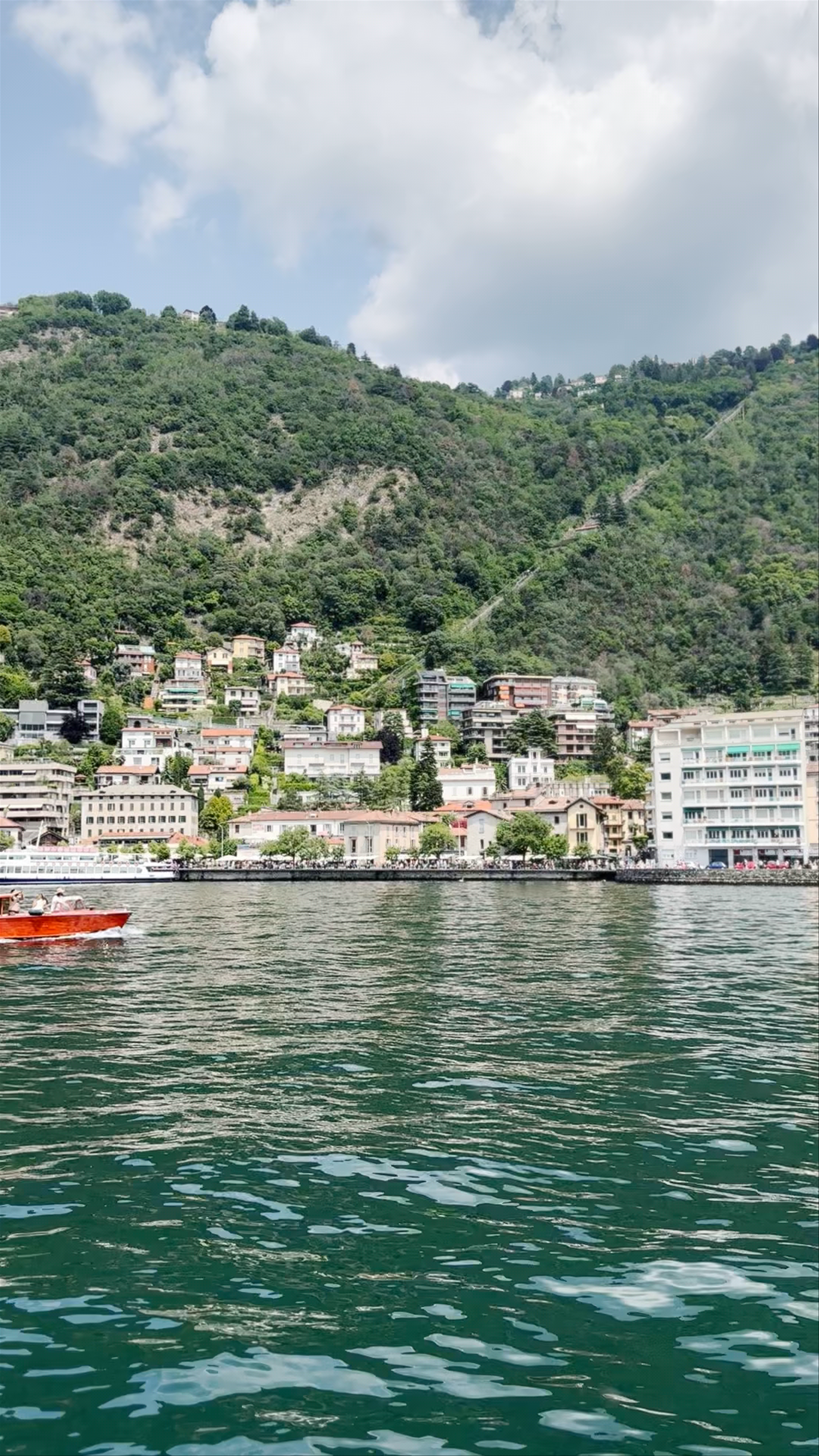 Serene Boat Ride on Lake Como with Scenic Hillside Views