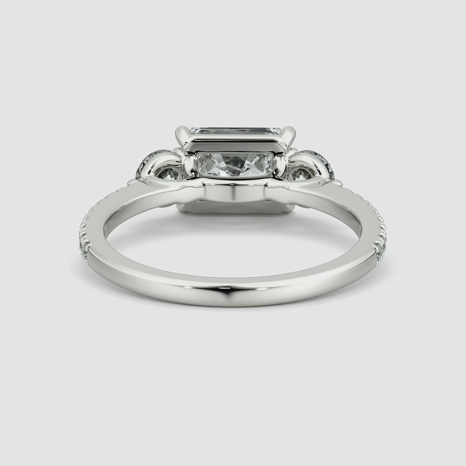 The Three Stone | Radiant | 18k | White Gold | bandAccent: Pavé | diamondOrientation: horizontal | sideStoneCarat: 0.25ct | sideStoneShape: Round Brilliant | caratWeight: other