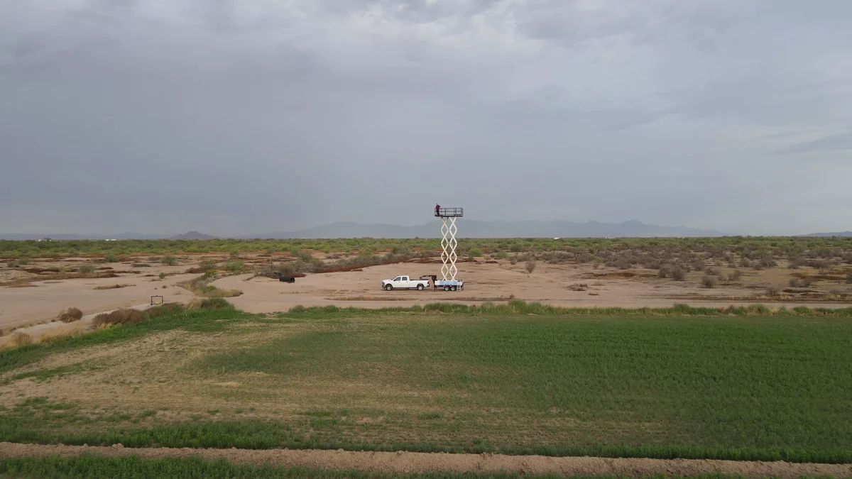 The raised Sky High Trailer standing tall above miles of open desert and distant mountains