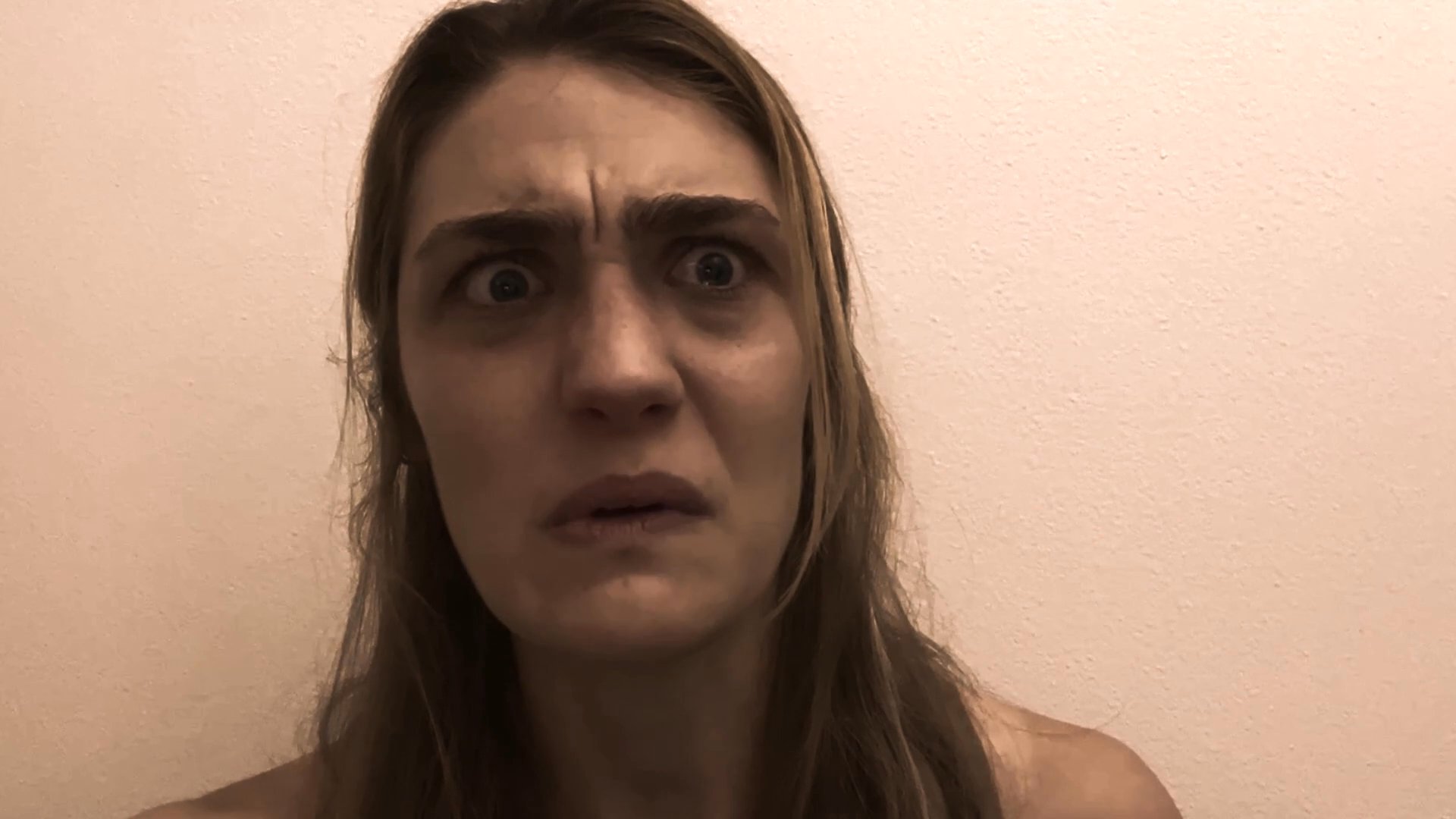 A woman delivers an emotionally charged account while facing a camera, framed within a digital surveillance interface. Her expressions convey significant distress and urgency as she communicates her experience.
