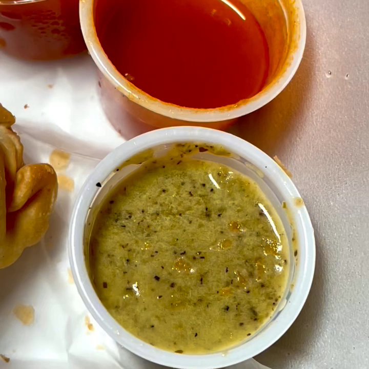 Latin Cravings - Hot sauce then Showing filling for beef (bottom) cheese (right) chicken (top) empanadas, they seem house made - Latin American Near Me - Bristol, Connecticut