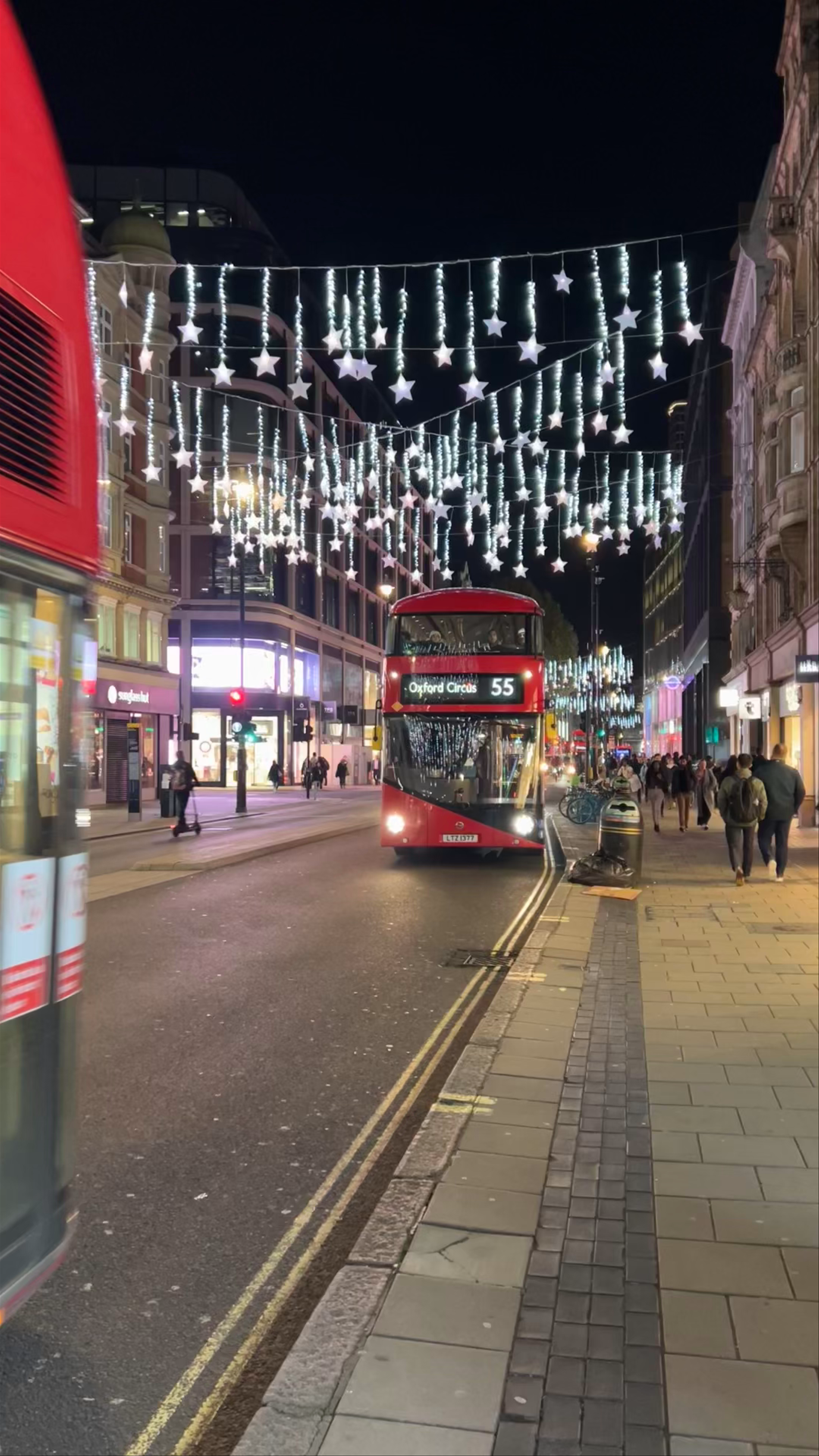 Nighttime Magic on Oxford Street: Festive Lights and Iconic London Red Buses