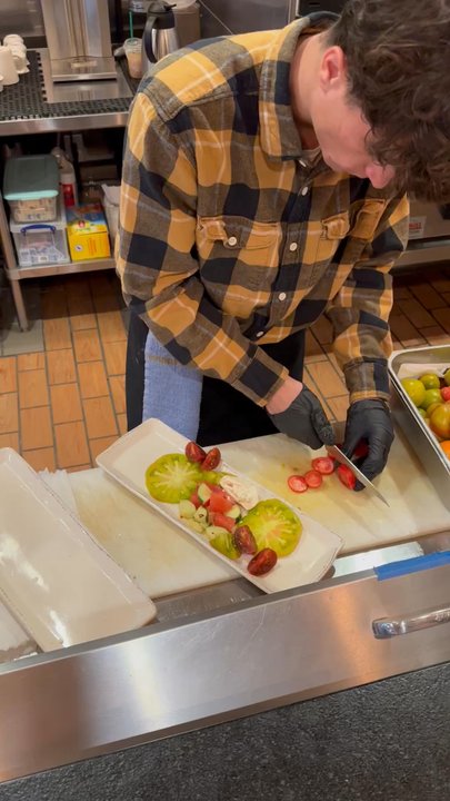 RANGE kitchen & tap - Here is a chef making their heirloom tomato salad.  He's very diligent.   Yummmmm - New American Near Me - Roseville, California
