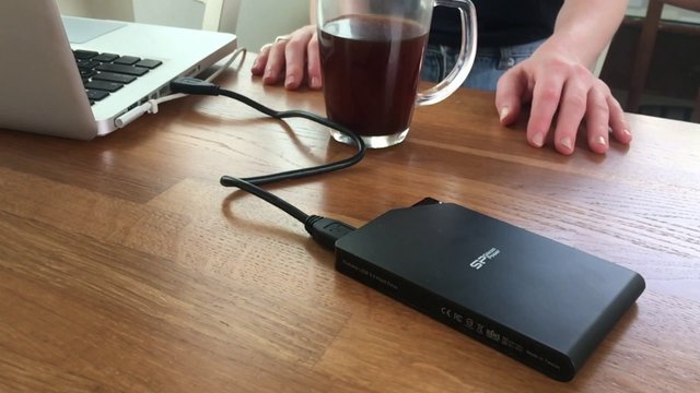 A woman spills a drink on her hard drive