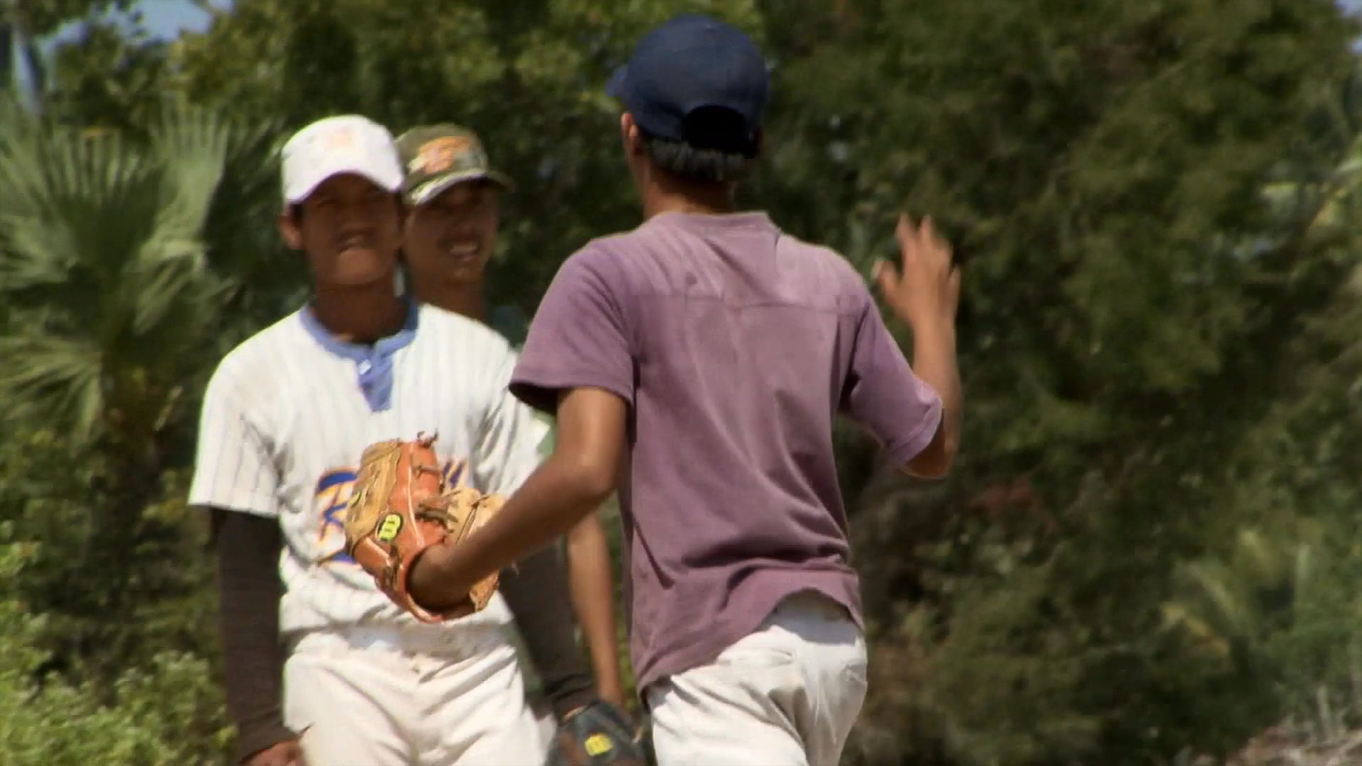 Young baseball players engage in structured practice sessions under the supervision of a coach, alternating between batting drills and fielding exercises on an outdoor field.