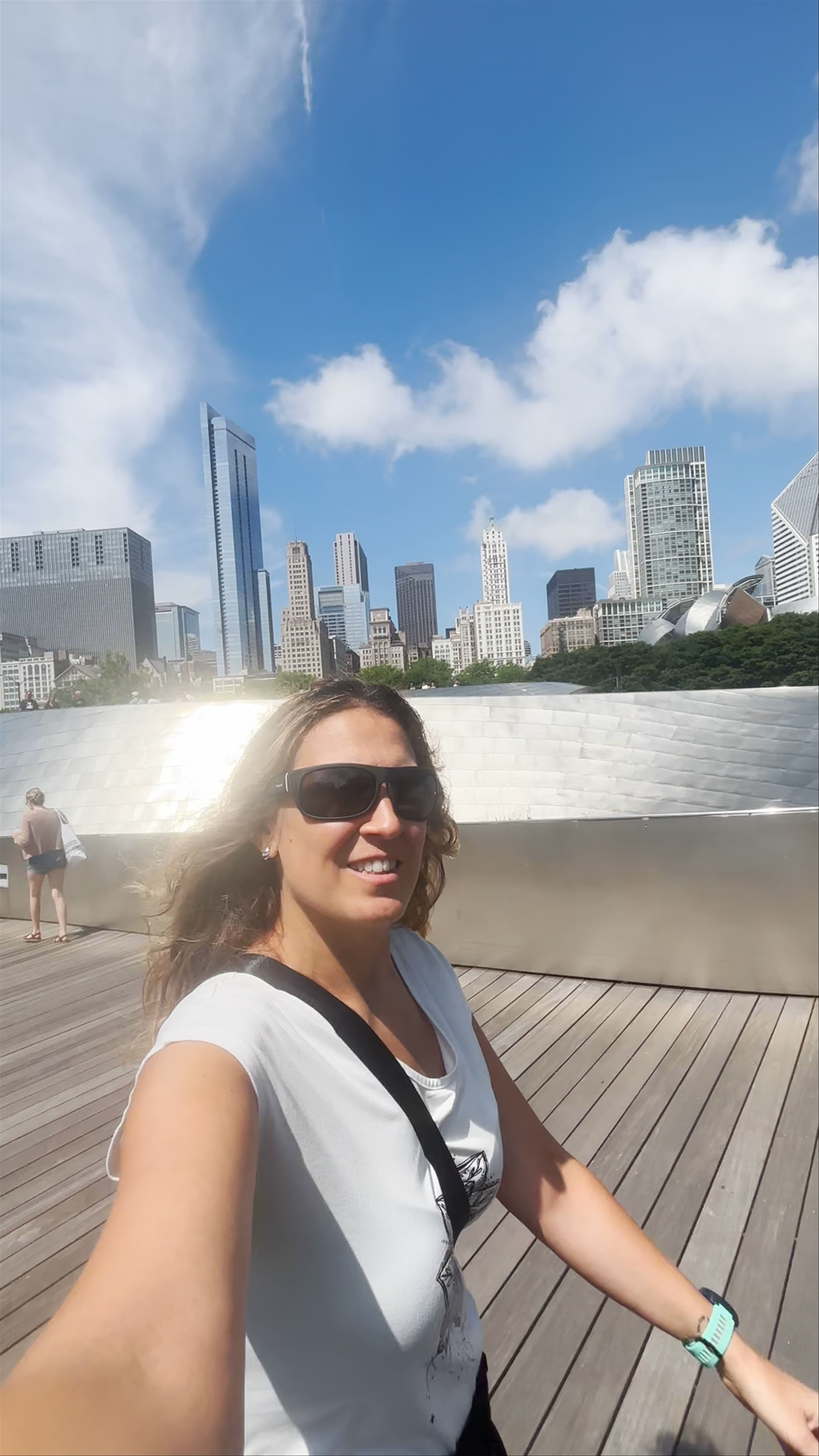 Sunlit Stroll on Chicago's BP Pedestrian Bridge with Skyline Views