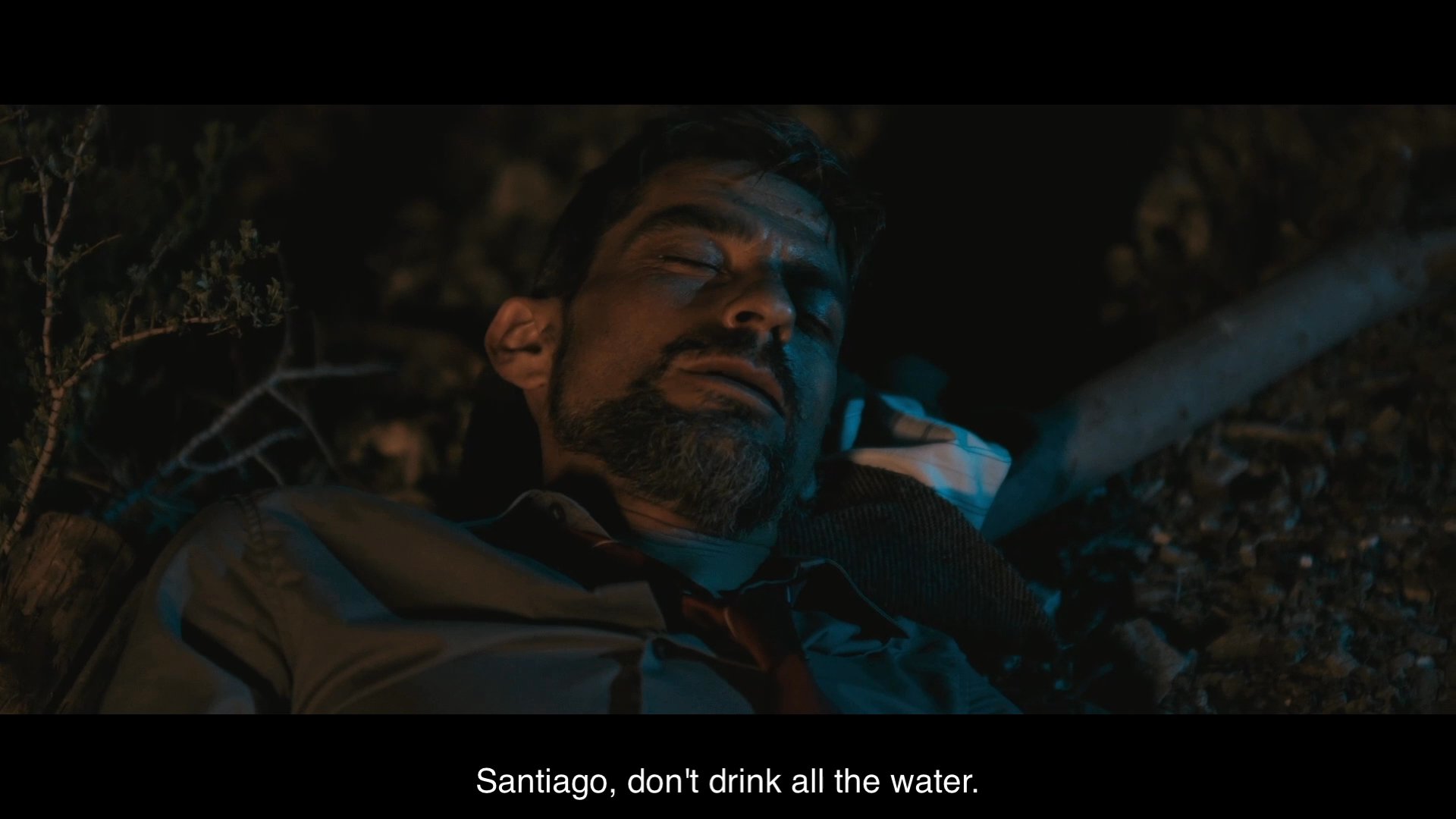 Two men travel through a desert environment at night while struggling with dehydration and limited water supplies. An argument erupts as one man consumes the shared water ration.