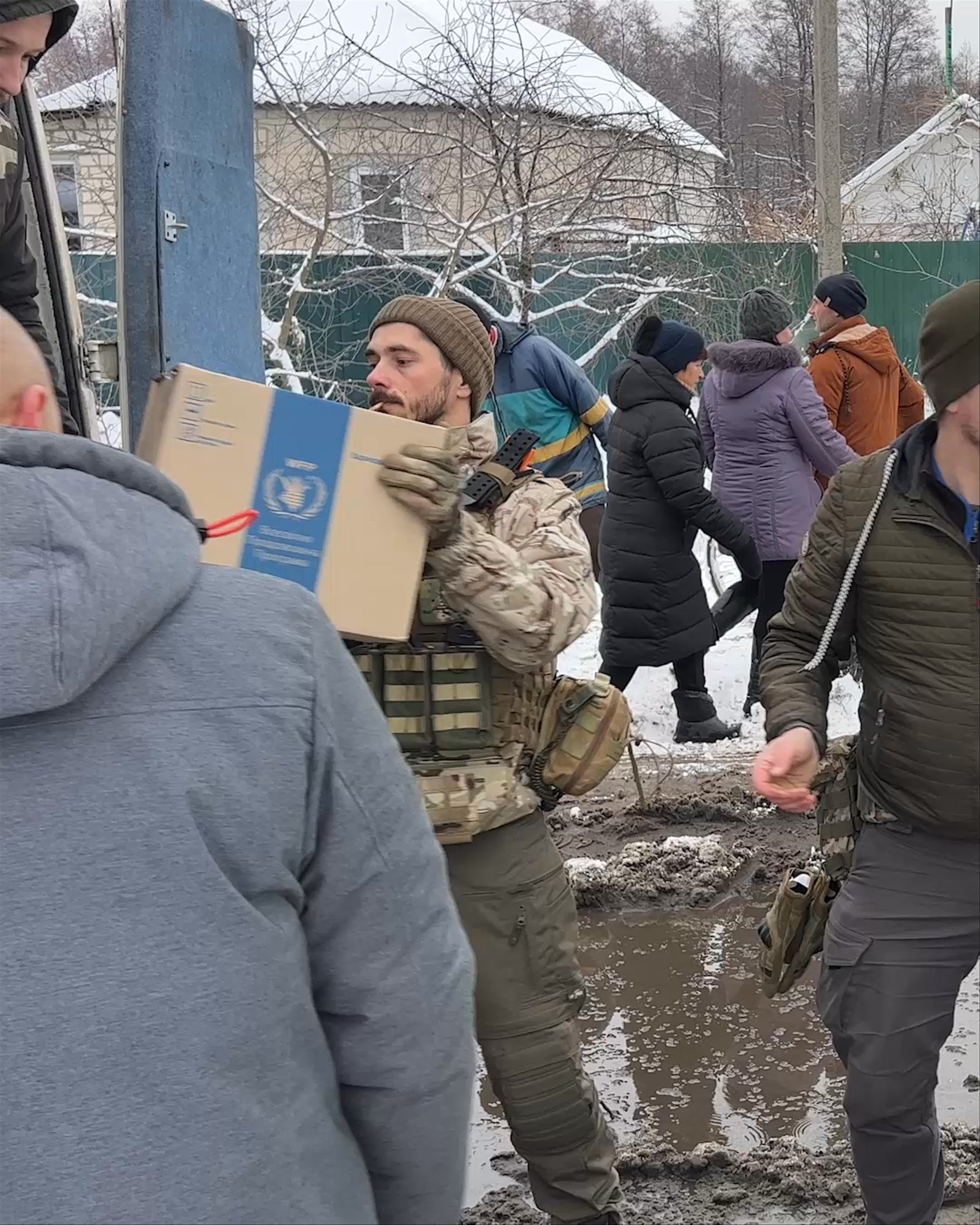 Video of men passing boxes of food rations between trucks