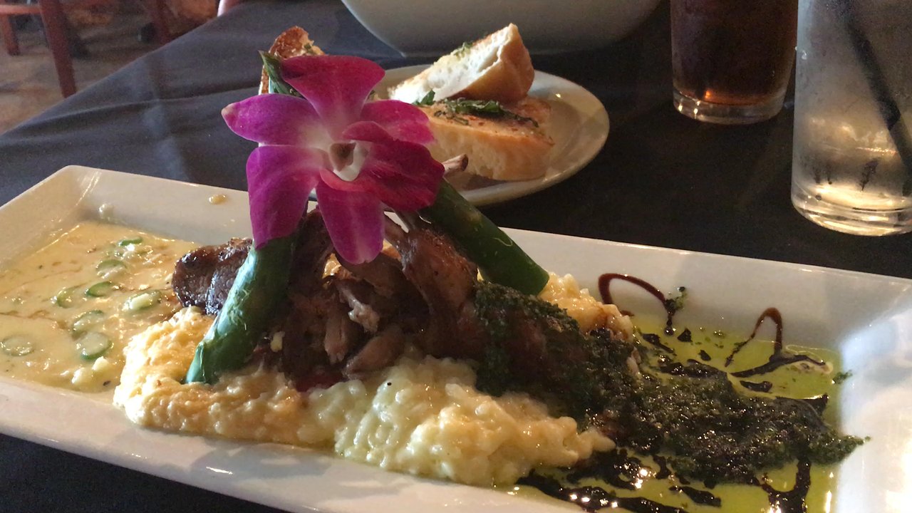 Main St Bistro - Lamb chop special with risotto and cheese grits. I didn't eat the flower.  But I ate everything else! - New American Near Me - League City, Texas