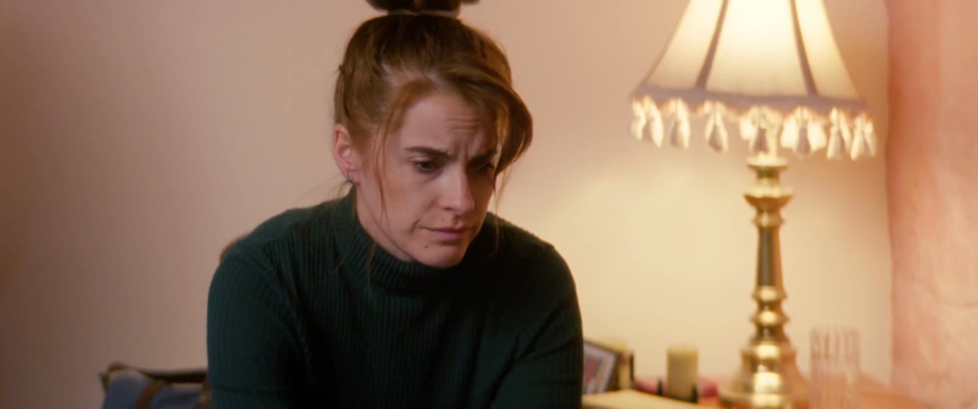 A sick individual rests in bed while receiving attentive care and medication from family members in a domestic setting. The scene highlights the personal interaction and support provided during a recovery period.