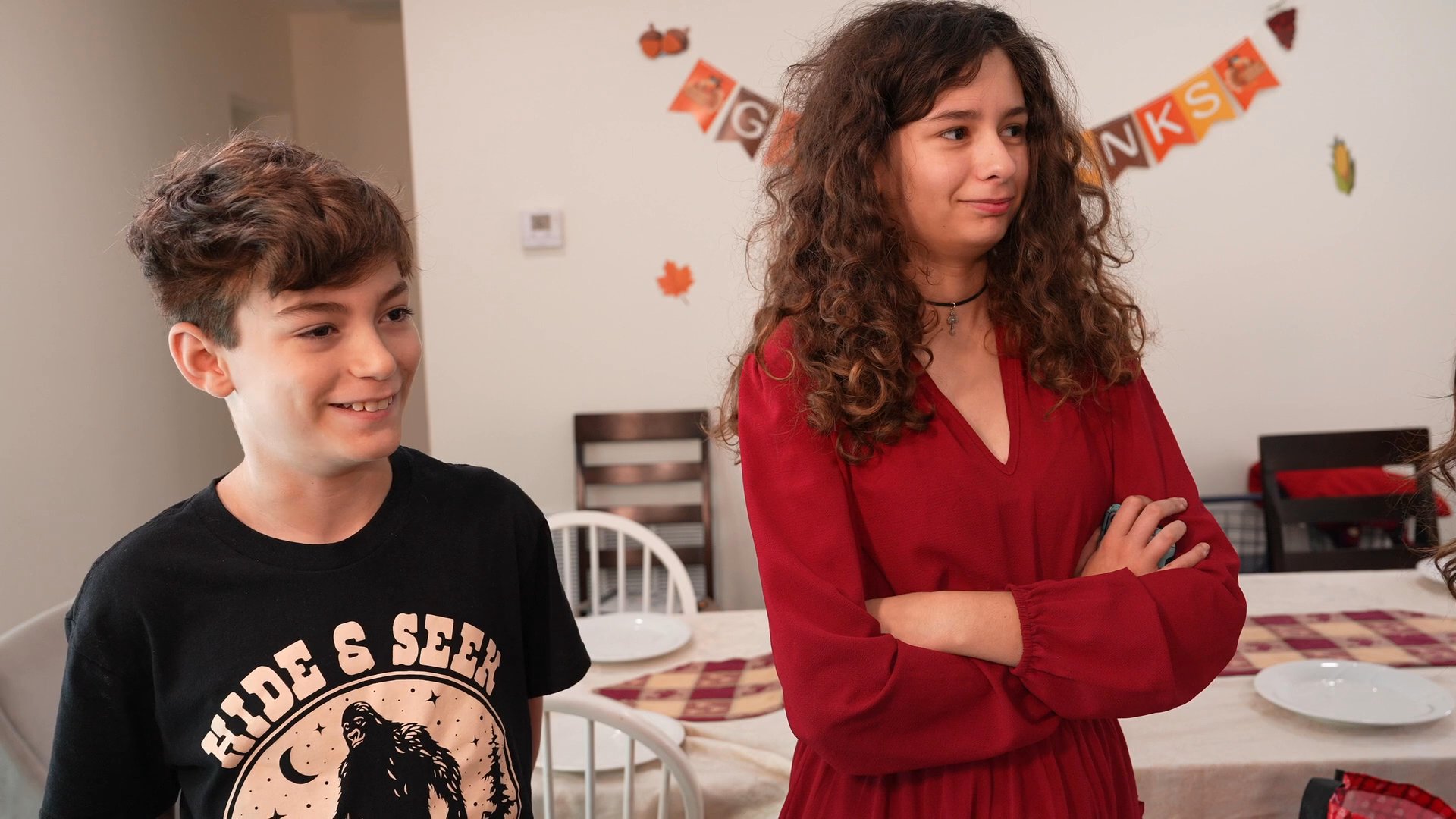 An informal home gathering transitions from casual conversation to a tense confrontation between multiple participants in a living room setting.