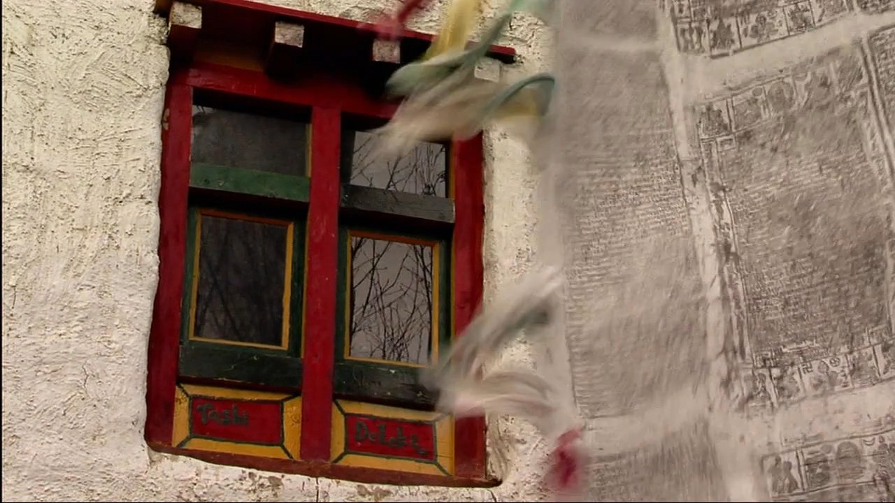 Explorers navigate a mountain monastery settlement in Nepal, interacting with locals and observing traditional architecture near the Himalayan peaks.