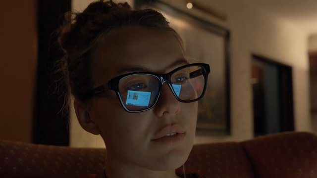 Girl wearing glasses while working on a laptop at home