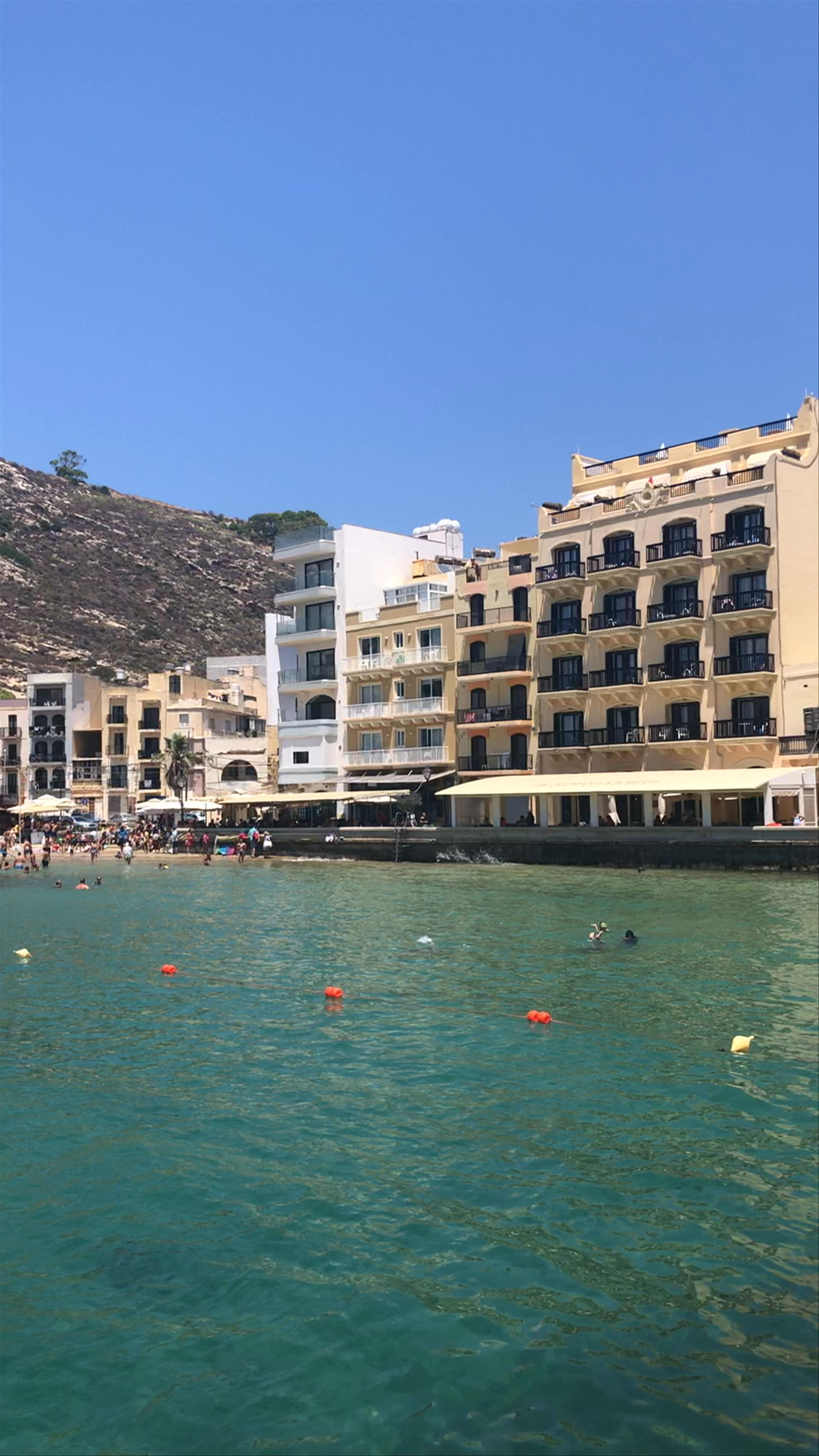 Sunlit Vibes at Xlendi Bay, Malta: Coastal Beauty and Relaxing Waters