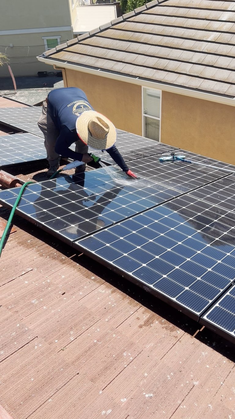 The Triple R crew cleaning solar panels.