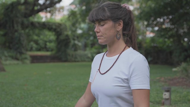 Girl doing a breathing meditation practice outdoors